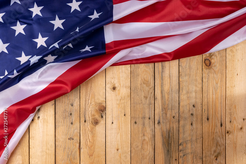 Flag of the United States of America on wooden background. USA holiday of Veterans, Memorial, Independence and Labor Day. © Phongsakorn