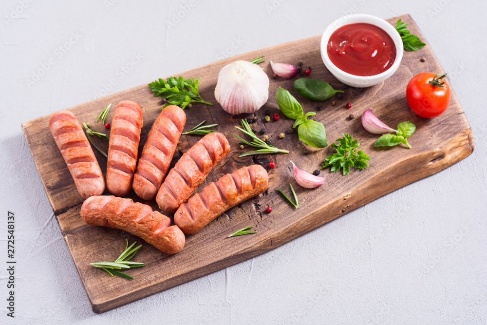Fried sausages with herbs , spices and ketchup Fried sausages with herbs , spices and ketchup