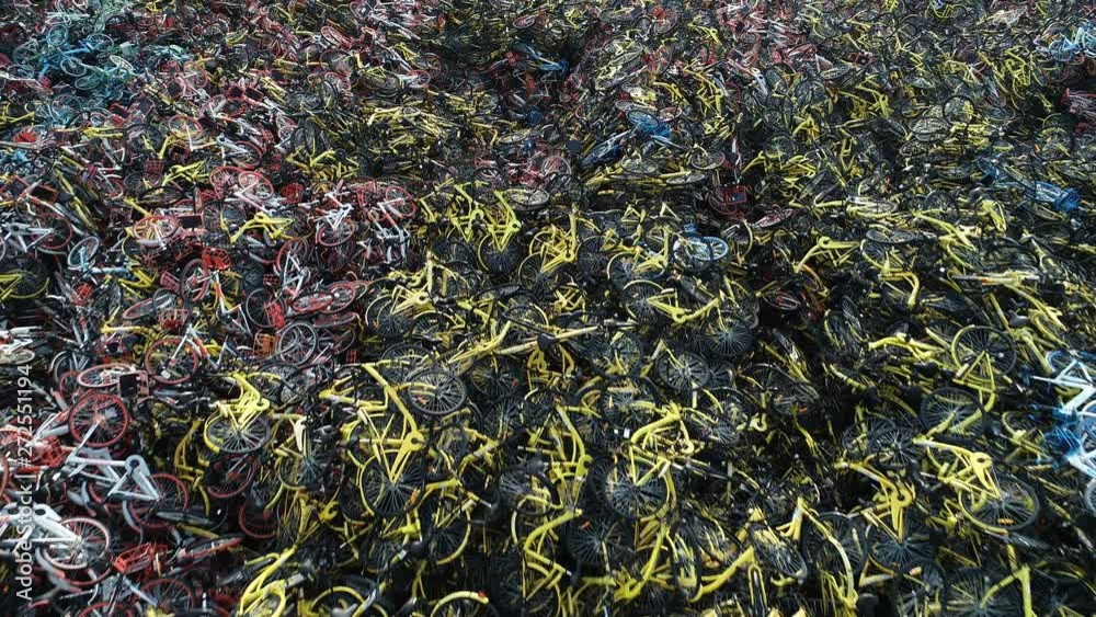 Abstract drone shot over piles of disposed rental bicycles in Shanghai, perhaps symbolizing a mismatch between government policy and liberal market economy in China Abstract drone shot over piles of disposed rental bicycles in Shanghai, perhaps symbolizing a mismatch between government policy and liberal market economy in China