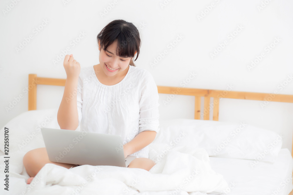 Beautiful of portrait asian young woman sitting relax and leisure with laptop computer internet online on bed in bedroom, cheerful of asia girl with gesture glad and success, lifestyle concept. Beautiful of portrait asian young woman sitting relax and leisure with laptop computer internet online on bed in bedroom, cheerful of asia girl with gesture glad and success, lifestyle concept.