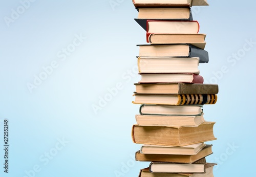 Stack of colorful books on background