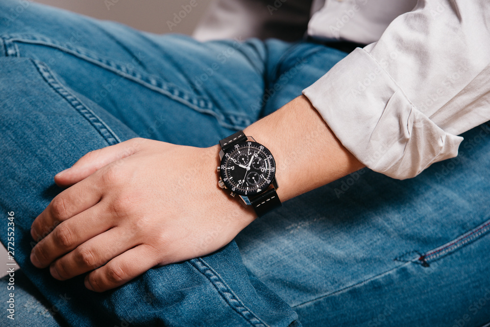 A man with a watch on his arm. Model