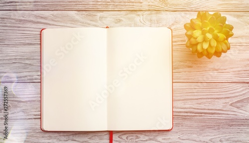 Blank notebook on wooden background photo