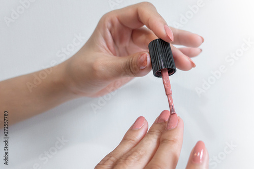 Close up of woman fingers is doing nail polish