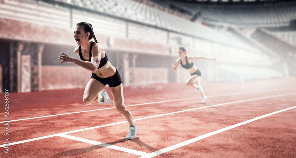 Fototapeta premium Kobieta sprinter w akcji na stadionie