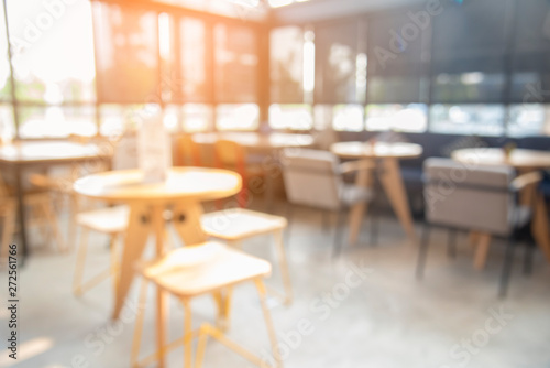 Blurred background cafe coffee shop with sun light. abstract of modern table design in restaurant.