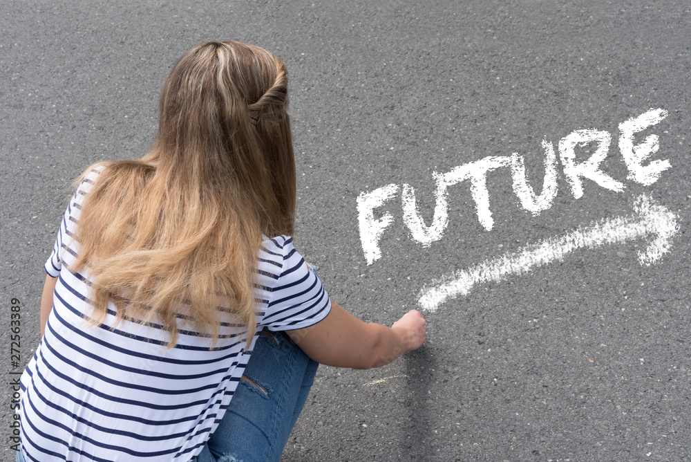 EIne junge Frau schreibt mit der Kreide das Wort Zukunft auf die Straße  Stock Photo | Adobe Stock