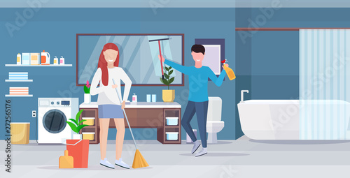 couple doing housework together man wiping glass mirror woman sweeping floor with broom cleaning housekeeping concept modern bathroom interior full length horizontal