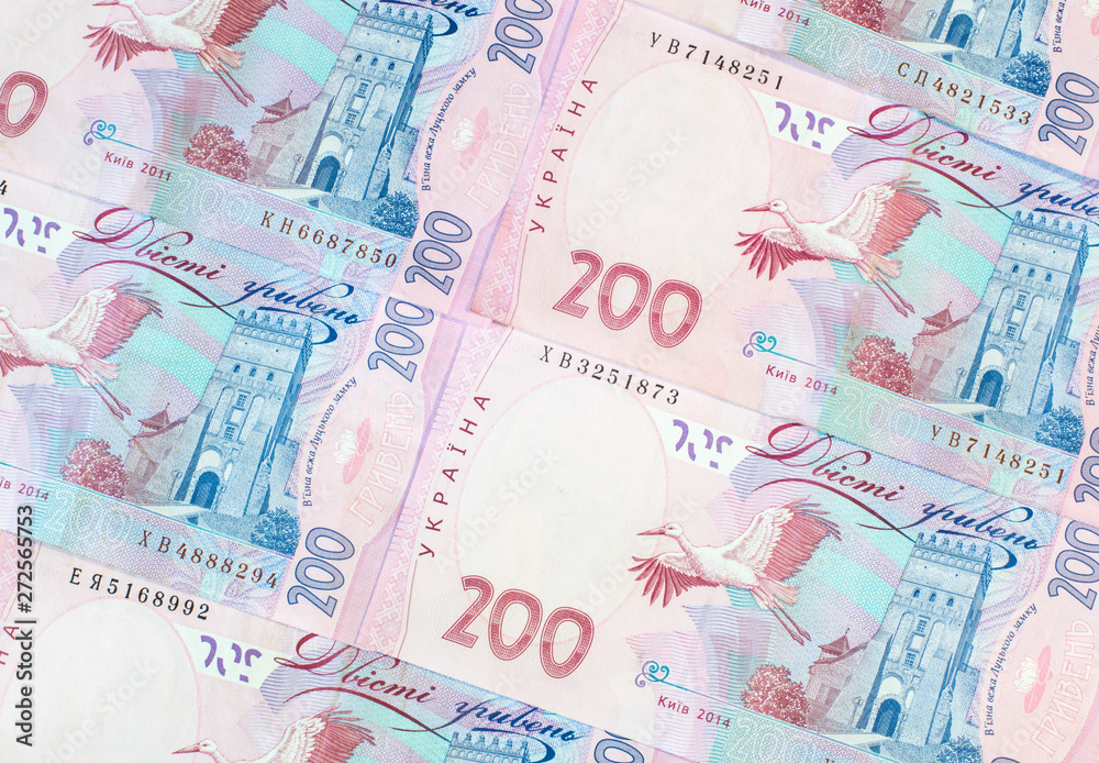 Ukrainian money. Hryvnia paper bill. Notes in denominations of two hundred hryvna. Uah. Cash. Background texture. Ukrainian money. Hryvnia paper bill. Notes in denominations of two hundred hryvna. Uah. Cash. Background texture.