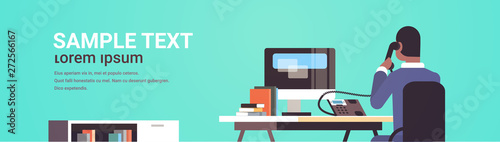 businessman sitting at workplace desk rear view african american business man using computer while talking on landline phone working process concept flat portrait horizontal copy space