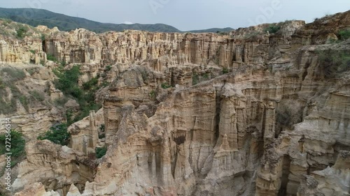 Wallpaper Mural Flying over stunning clay pillars in Yuanmou Earth Forest park, natural scenery and surreal landscape in Southern China Torontodigital.ca