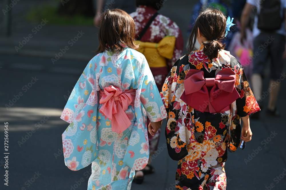 Two japanese girls in red kimonos on a carnival event in Berlin-Germany.