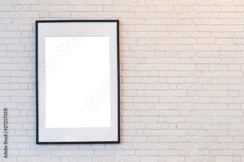 Beautiful black wooden picture frame on white brick wall with space for text and advertising