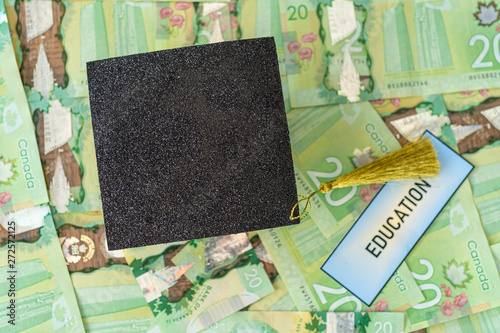 University Mortarboard academic cap on Canadian Dollar notes