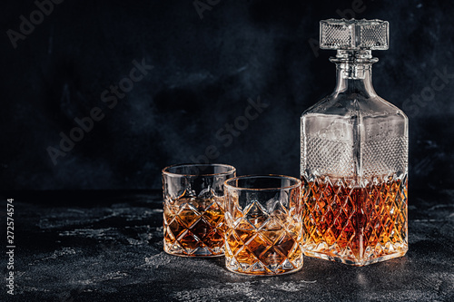 Canvas Print Glasses of the whiskey with a square decanter