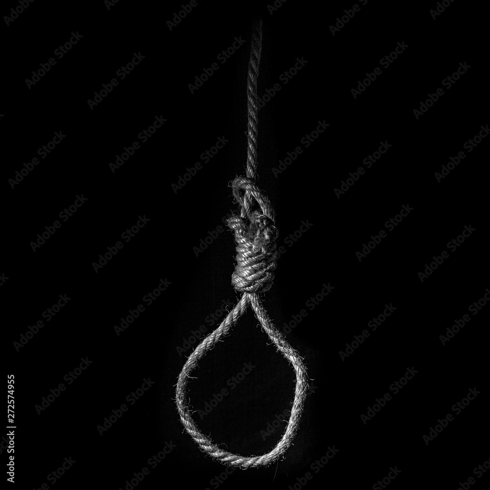 Loop of braided rope on a gloomy dark background, failure or suicide  concept Stock Photo