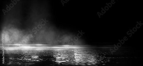Foto Wet asphalt, reflection of neon lights, a searchlight, smoke