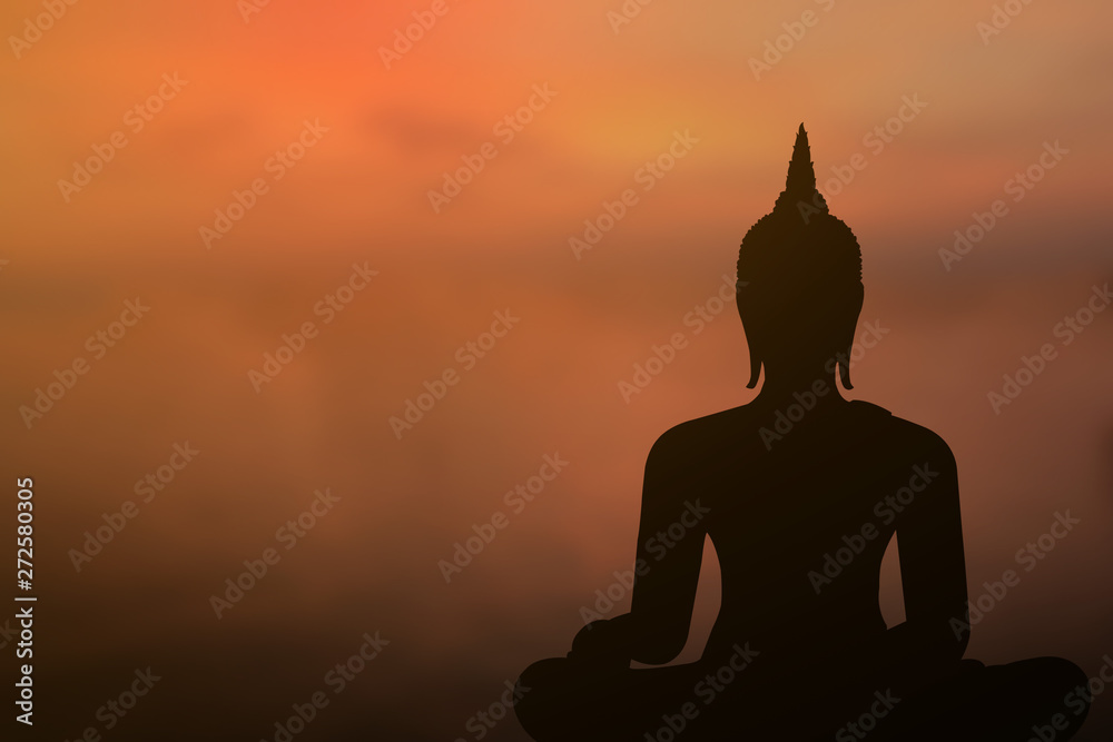 Buddha sitting on the sunset, orange, orange sky with clouds as background- Image