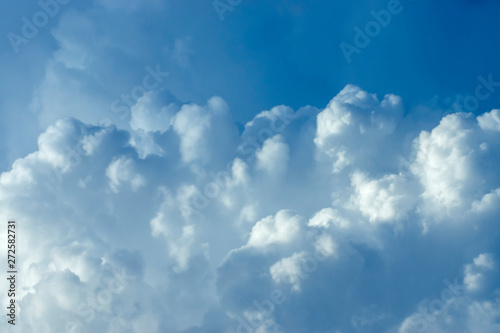 Blue sky background with white clouds.