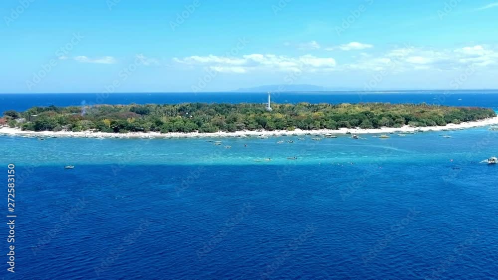 Aerial view of boats in turquoise waters on a tropical island. Aerial view of boats in turquoise waters on a tropical island.