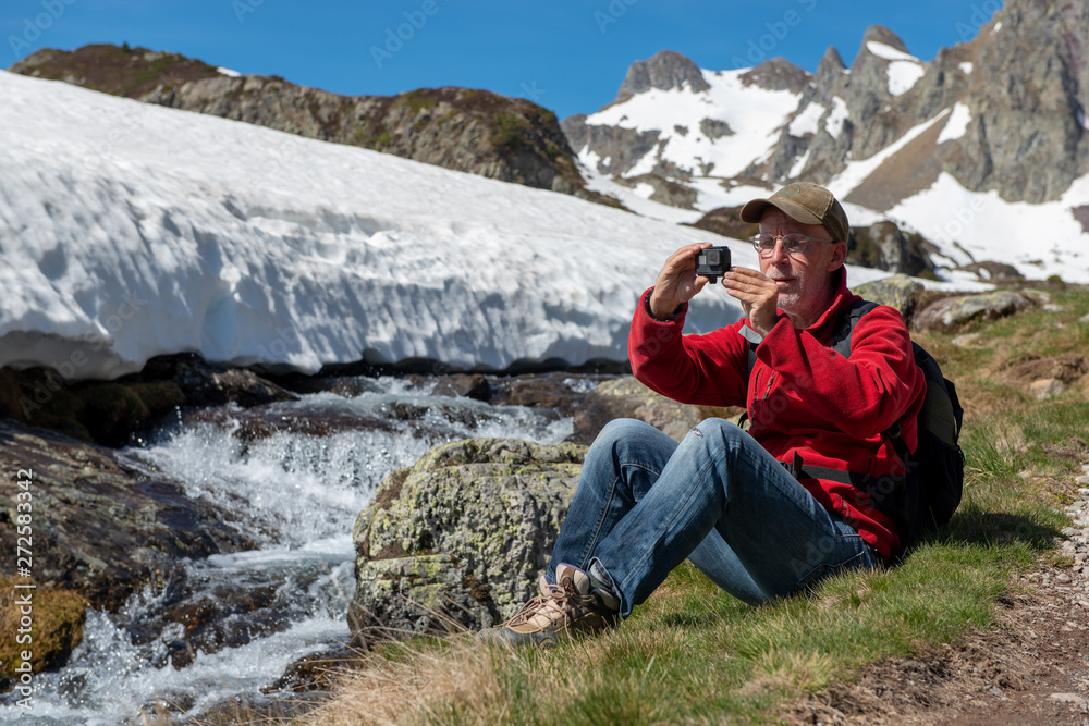 Naklejka premium hiker man take a picture with action camera