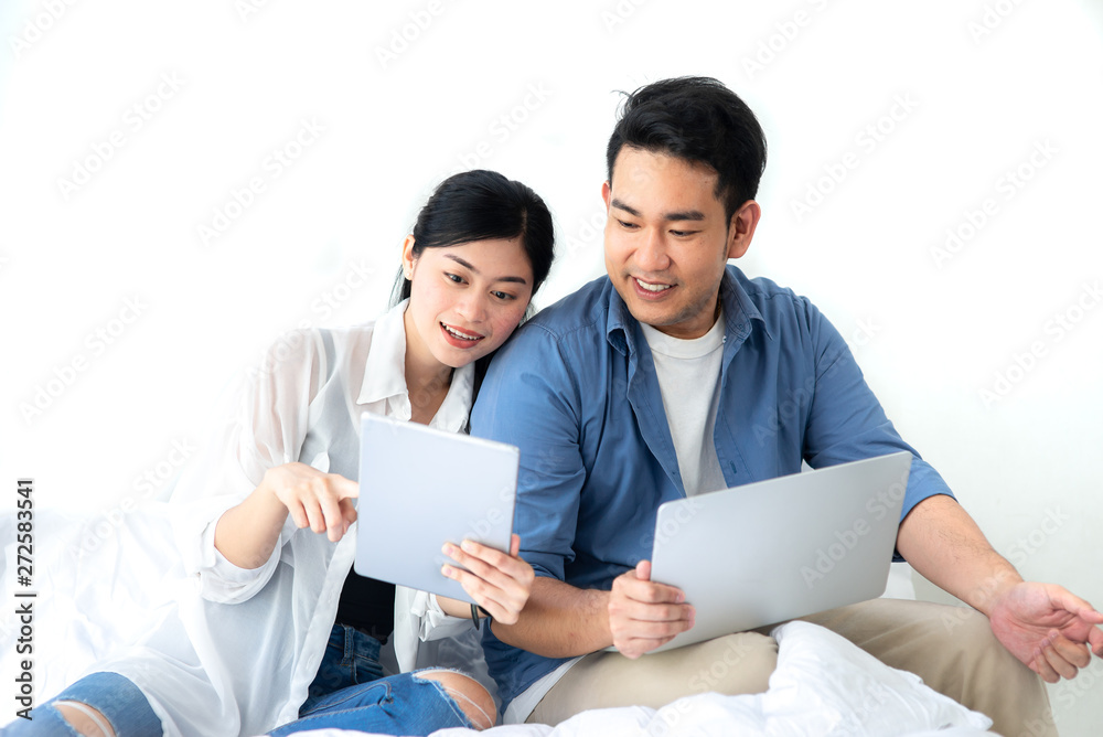 Happy Asian couple using laptop at home, lifestyle concept. Happy Asian couple using laptop at home, lifestyle concept.