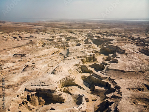 Canyon in the Judean Desert. Aerial view of the Judean desert located on the West Bank of the Jordan river. Deserted shore of dead sea. The background of desert. Stony canyon in desert. photo