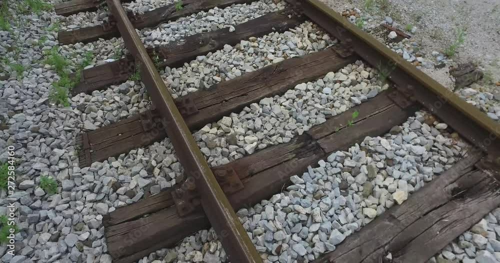 The rails of the train wrapped in grass and wildflowers that grow from stones. The rails of the train wrapped in grass and wildflowers that grow from stones.