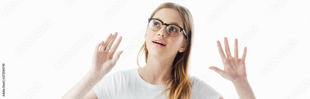 panoramic shot of curious teenage girl in glasses gesturing isolated on white