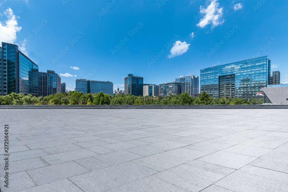 Panoramic skyline and modern business office buildings with empty road,empty concrete square floor Panoramic skyline and modern business office buildings with empty road,empty concrete square floor