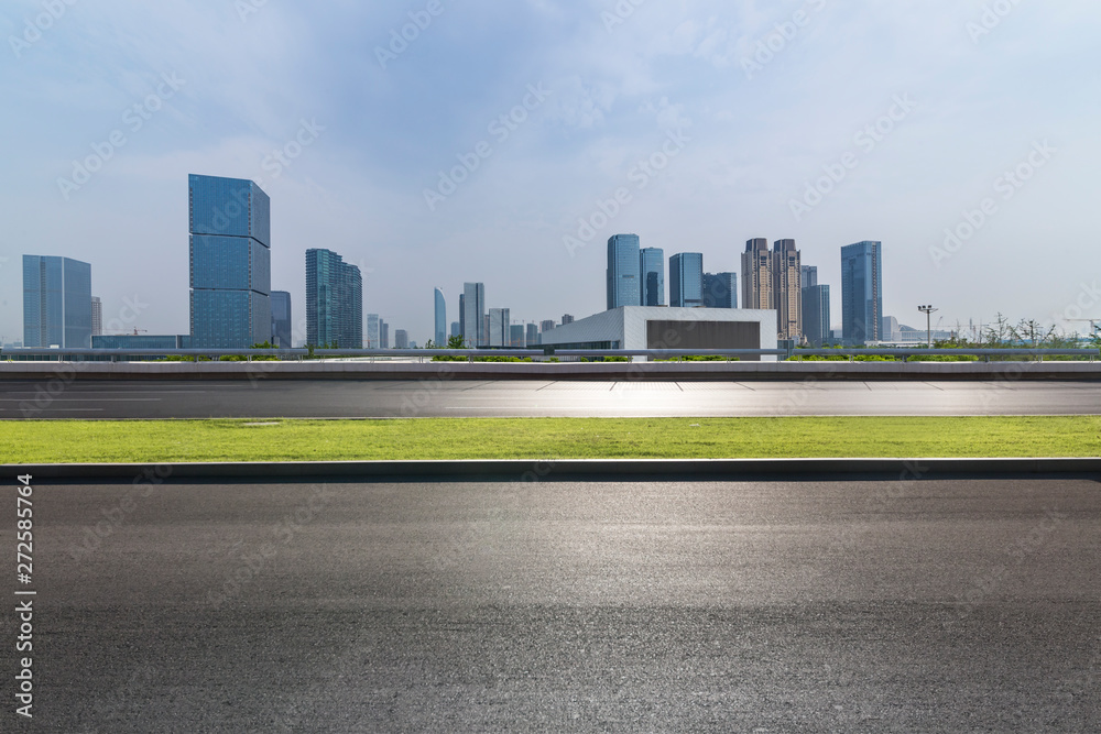 Panoramic skyline and modern business office buildings with empty road,empty concrete square floor Panoramic skyline and modern business office buildings with empty road,empty concrete square floor