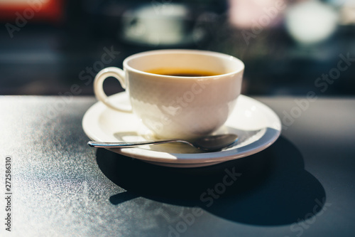 Cup of black coffee on table