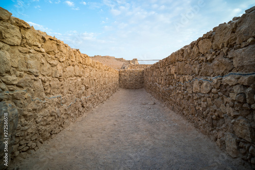 View to old stone blind alley. Architecture of ancient civilization. Masada paths and passages, Israel. Labyrinth dead-end. Concept of deadlock. Be at deadlock. Searching for way out in labirinth. photo