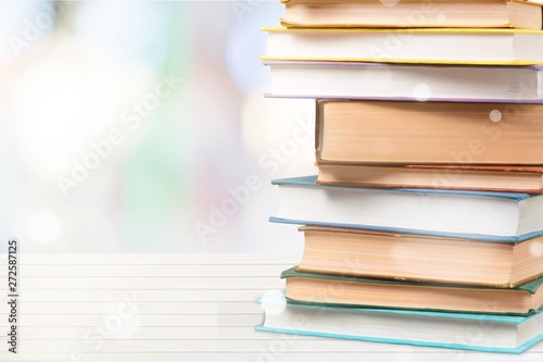Stack of colorful books on white desk