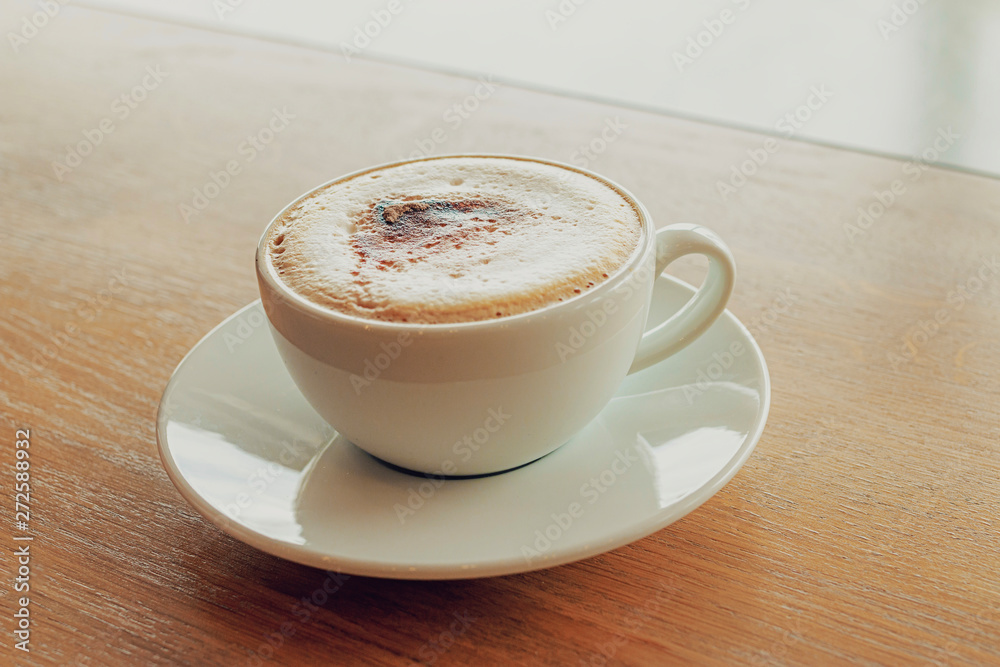 Cup of coffee cappuccino on wooden bar in cafe. Cup of coffee cappuccino on wooden bar in cafe.
