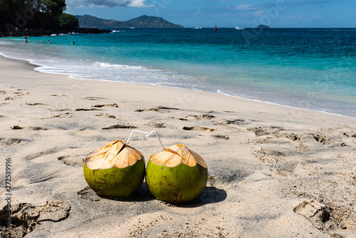 Two Fresh Coconut Cocktails on the Beautiful Beach at Sunny Day
