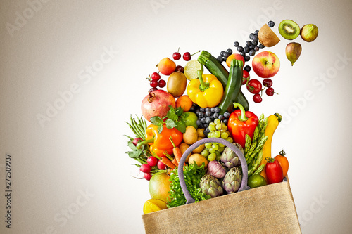 Bananas and kiwifruits in pile of vegetables
