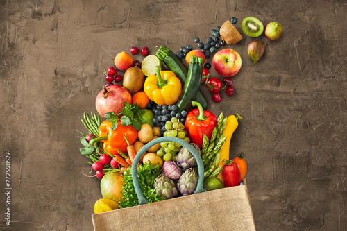 Many different vegetables falling out of bag