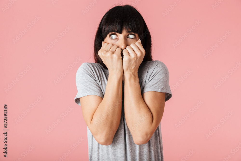 Amazing scared shocked woman posing isolated over light pink background wall. Amazing scared shocked woman posing isolated over light pink background wall.