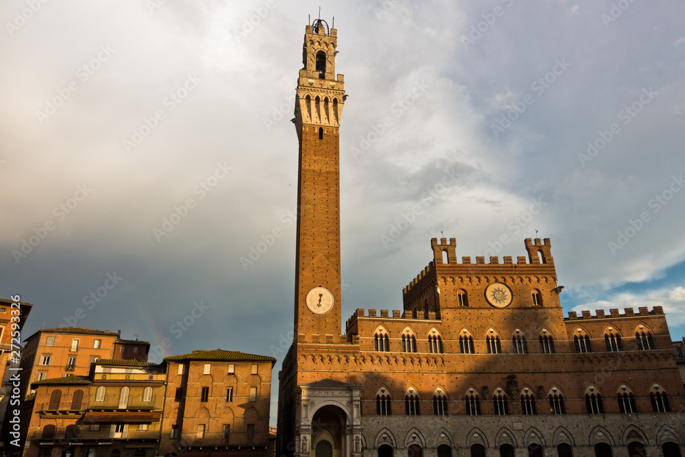 Torre del Mangia, clock tower of a city hall on Piazza del Campo main square in Siena, Tuscany, Italy