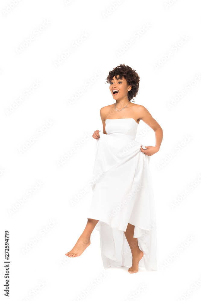 happy african american bride touching wedding dress and walking isolated on white happy african american bride touching wedding dress and walking isolated on white