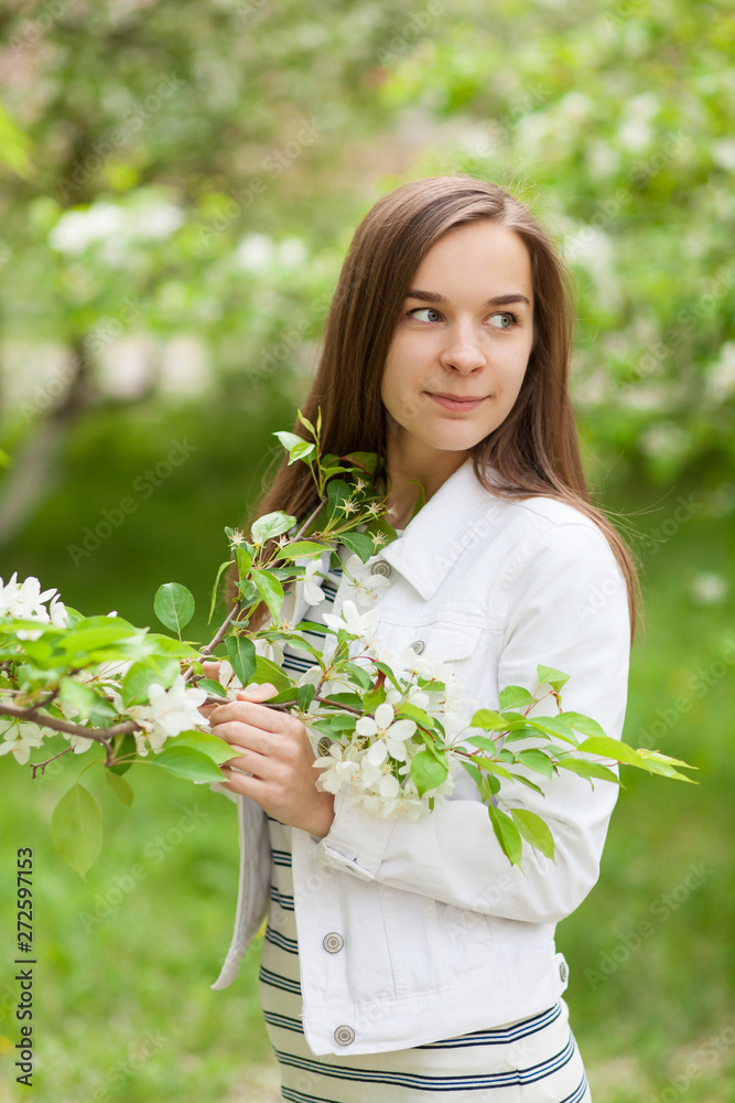 Beautiful girl blowing. portrait of a girl in a blooming apple tree. Beautiful girl blowing. portrait of a girl in a blooming apple tree.