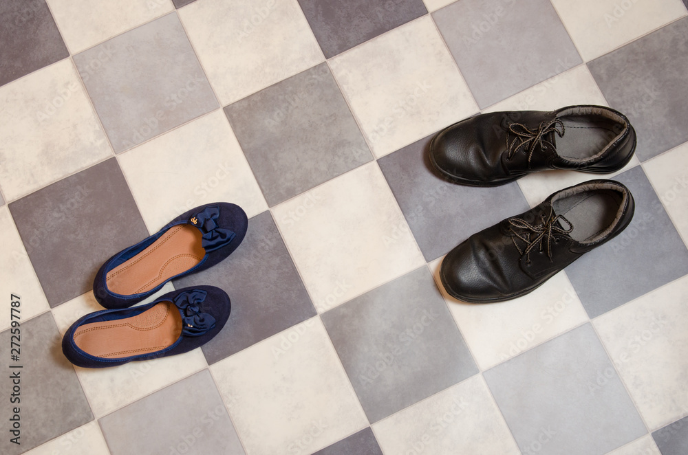 light and comfortable blue women's shoes and man's shoes on black and white checkered floor light and comfortable blue women's shoes and man's shoes on black and white checkered floor