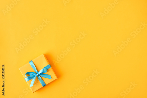  Gift box with ribbon and bow on color background and space for text. Top view © Veliavik