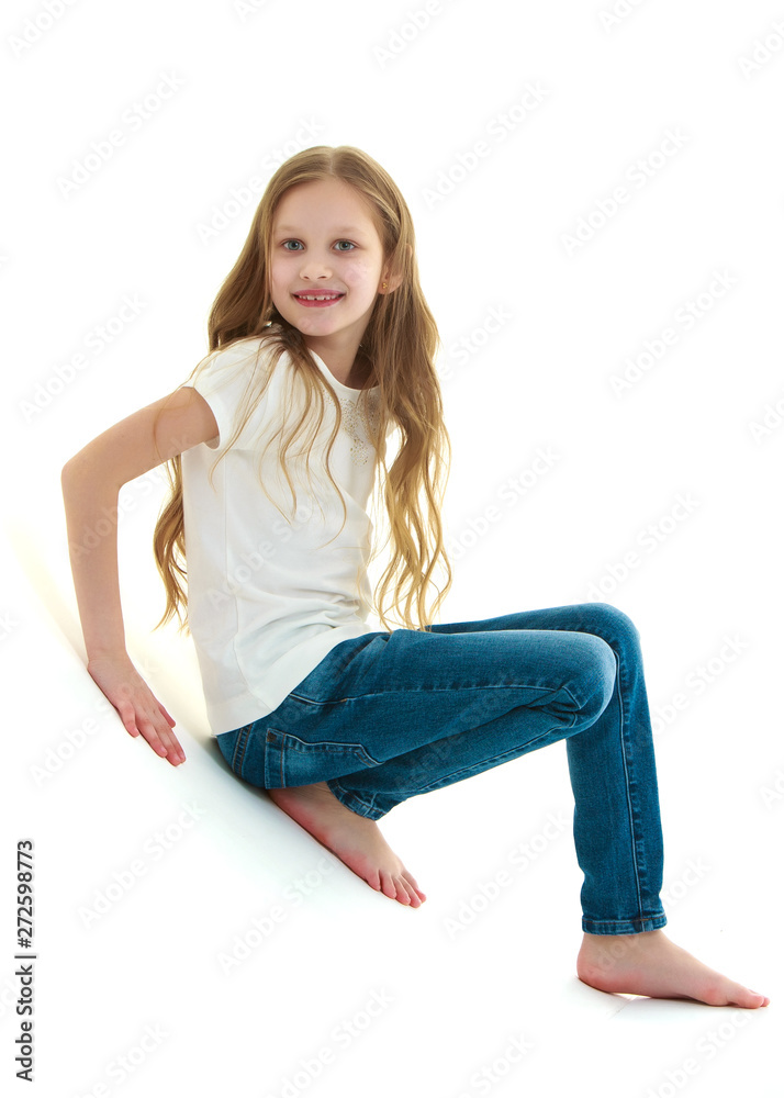 A little girl is photographed in the studio on a cyclorame. A little girl is photographed in the studio on a cyclorame.