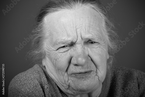 Portrait of elderly woman. Discontent. Toned
