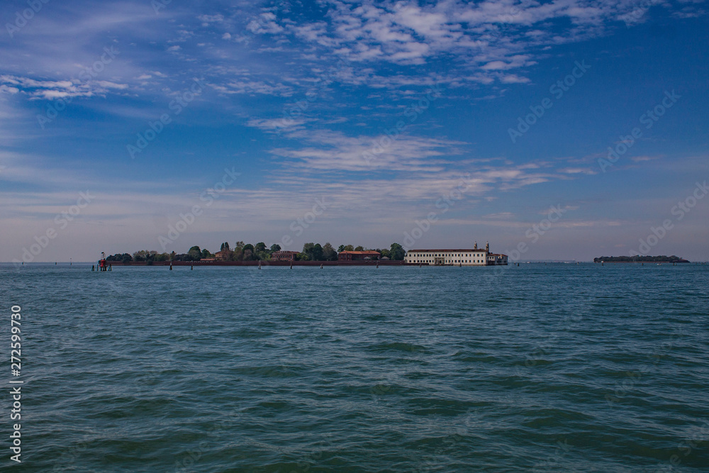 View of the islands, Venice, Italy. Lagoon on a bright summer day. Seascape with two islands, trees and houses on them. View of the islands, Venice, Italy. Lagoon on a bright summer day. Seascape with two islands, trees and houses on them.