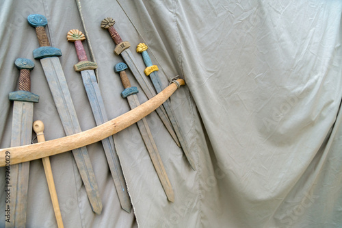 Medieval weapons for close combat displayed on grey fabric textu photo