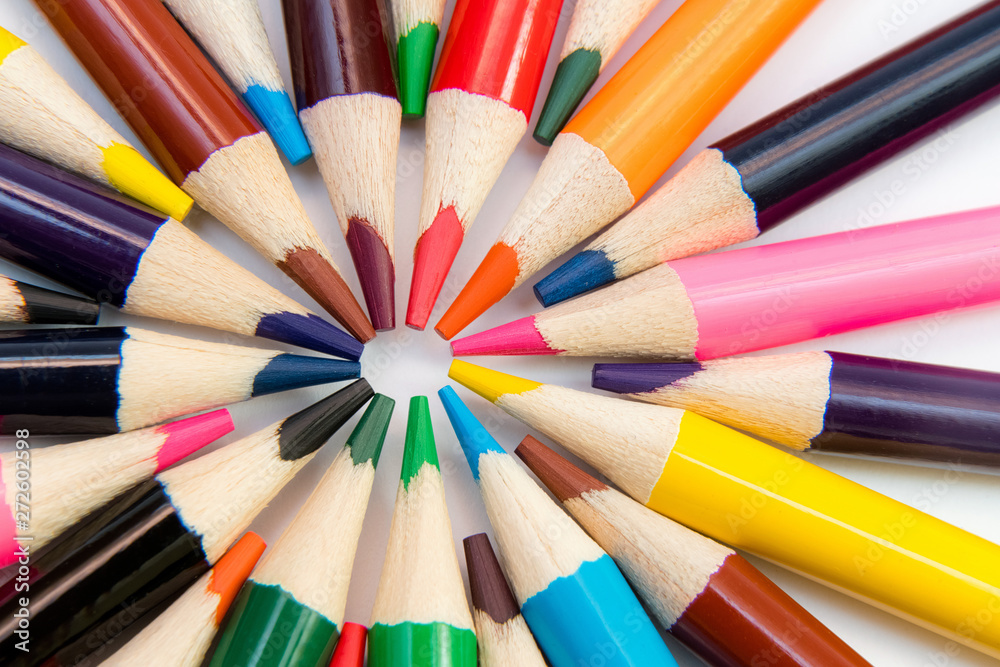 An assortment of colour pencils in circle, spiral on white backg An assortment of colour pencils in circle, spiral on white backg