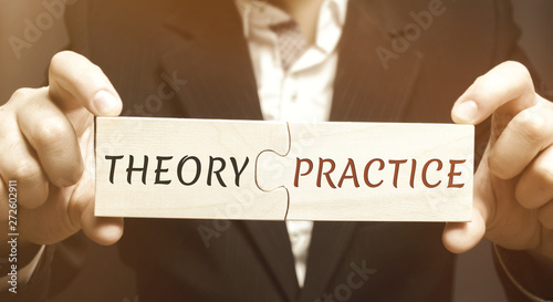 A businessman collects wooden puzzles with the word Theory and Practice. Obtaining information and application it in practice. Getting experience. Psychology and science. Knowledge economy.